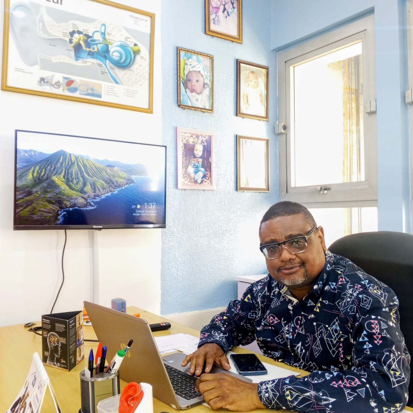 Dr Mahin Abdilahi Mohamed at his desk in the Mombasa Hearing Centre consulting room